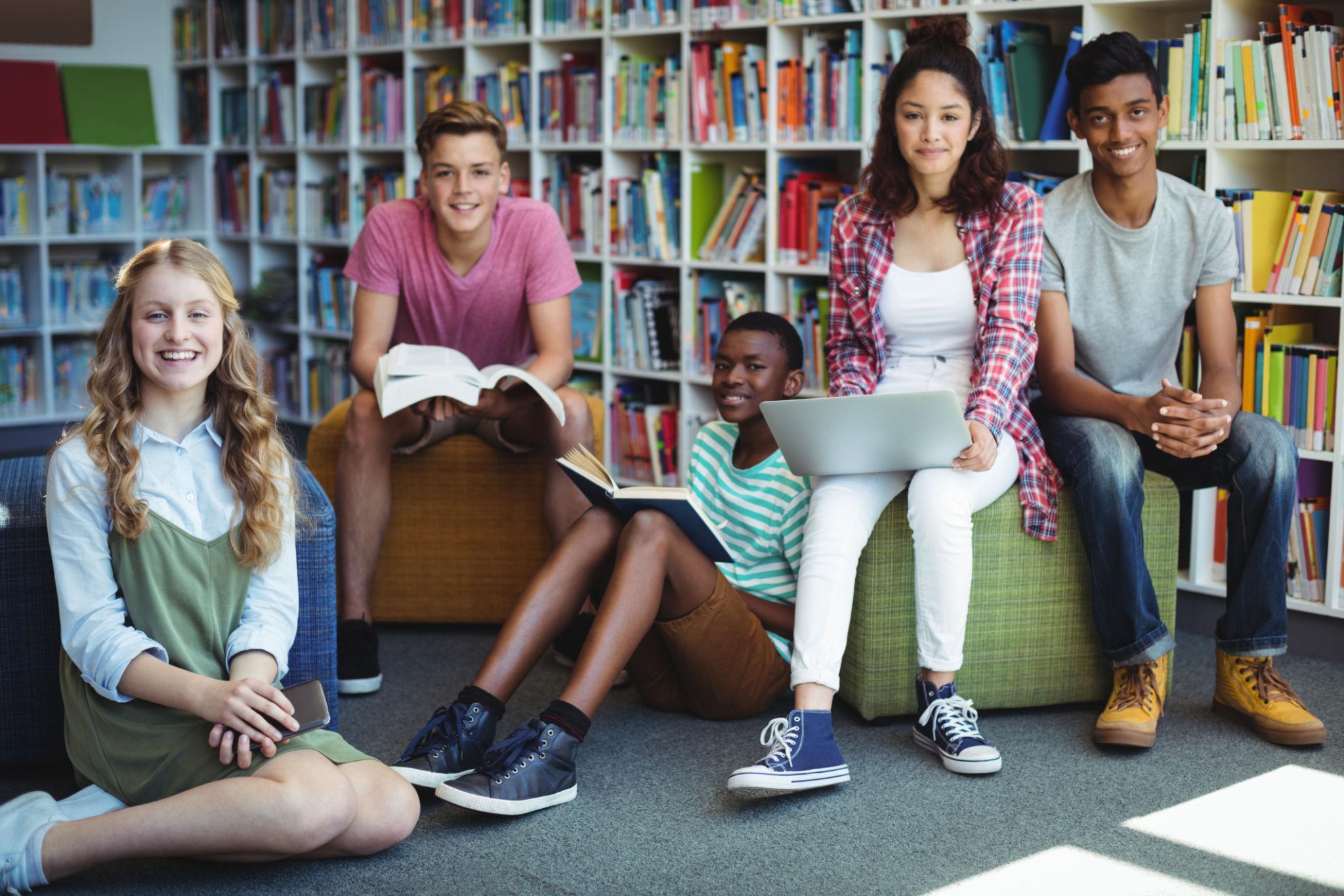 Portrait of happy students in library at school